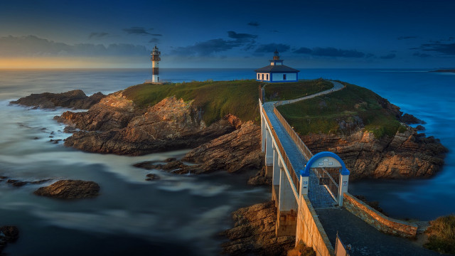 Lighthouse rocky cliff ocean night free wallpaper for desktop - medium preview image
