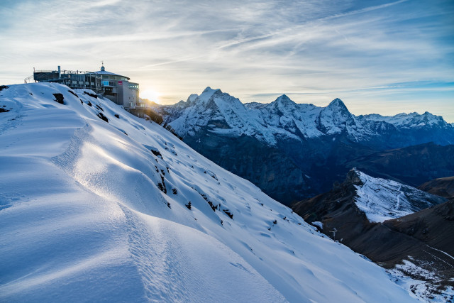 Snowboarder snowy hill building mountains free wallpaper for desktop - medium preview image
