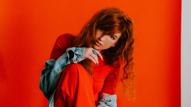 Red haired woman sitting backpack free wallpaper for desktop - medium preview image