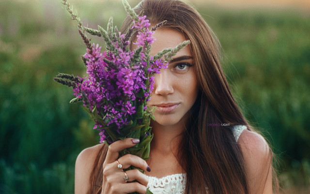 Woman holding flowers serious portrait free wallpaper for desktop - medium preview image