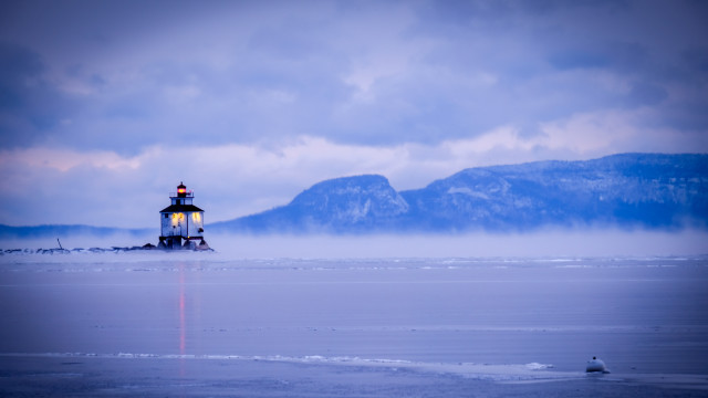 Lighthouse snowy beach mountains water free wallpaper for desktop - medium preview image