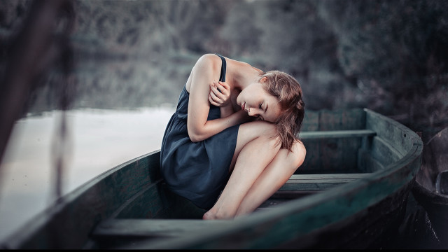 Woman sitting boat lake rain free wallpaper for desktop - medium preview image