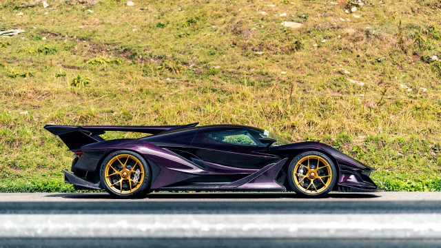 Purple sports car grassy hill free wallpaper for desktop - medium preview image