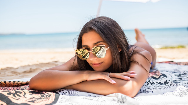 Beach woman sunglasses lying sand free wallpaper for desktop - medium preview image