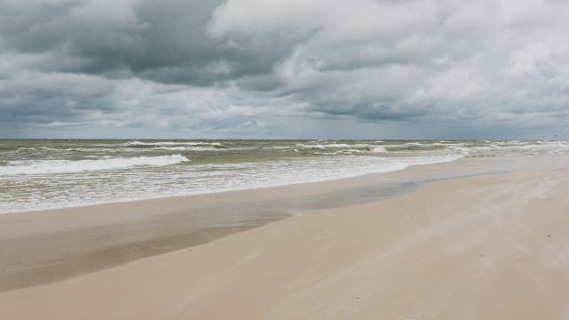 Sandy beach waves cloudy sky free wallpaper for desktop - medium preview image