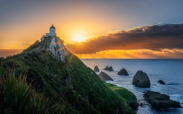 Lighthouse hill sunset ocean rocks free wallpaper for desktop - medium preview image