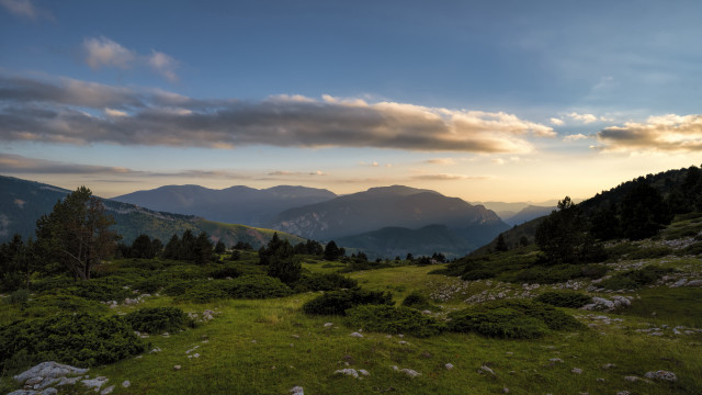 Grassy field mountains sunset clouds #2 free wallpaper for desktop - medium preview image