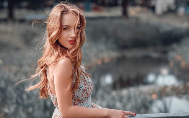 Woman leaning pond blurry bokeh free wallpaper for desktop - medium preview image