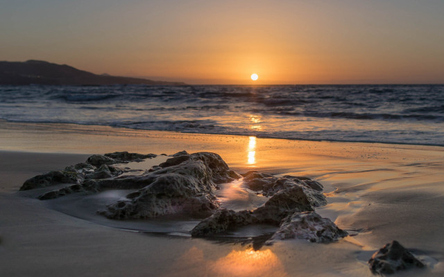 Sunset ocean rocks beach mountain free wallpaper for desktop - medium preview image