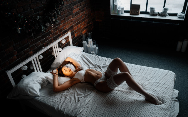 Woman laying bed brick wall free wallpaper for desktop - medium preview image