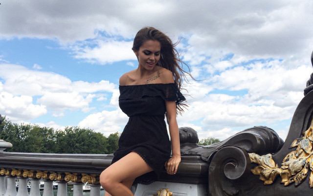 Woman black dress leaning railing free wallpaper for desktop - medium preview image