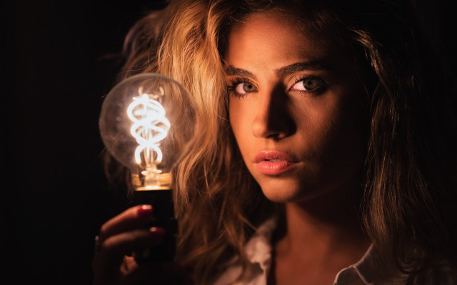 Woman lightbulb serious portrait photorealistic free wallpaper for desktop - medium preview image