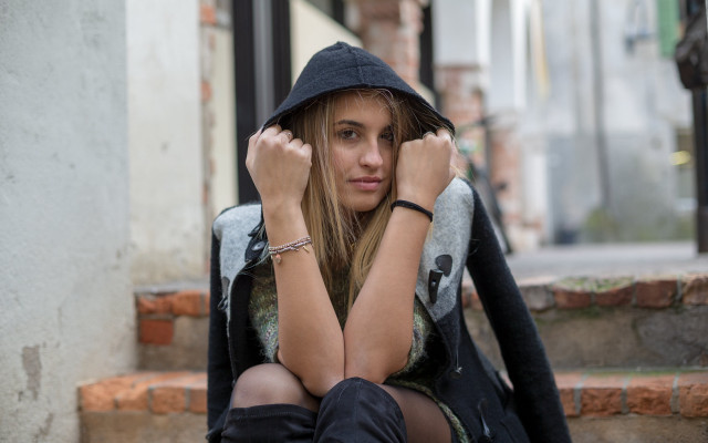 Woman sitting hooded portrait blurry free wallpaper for desktop - medium preview image