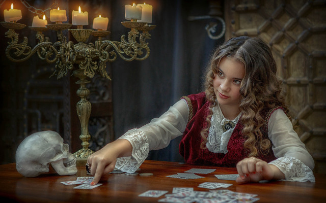 Young girl playing cards candle free wallpaper for desktop - medium preview image