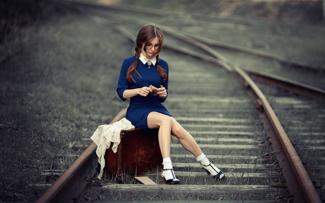 Woman sitting suitcase train track free wallpaper for desktop - medium preview image