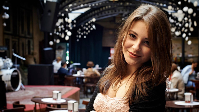 Smiling woman cafe bokeh portrait free wallpaper for desktop - medium preview image