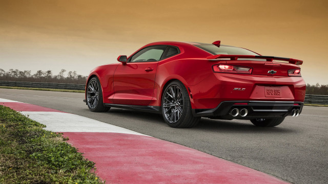 Red sports car road curb free wallpaper for desktop - medium preview image