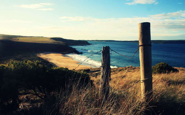 Wooden post grassy hill ocean free wallpaper for desktop - medium preview image