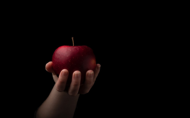 Person apple black background food free wallpaper for desktop - medium preview image