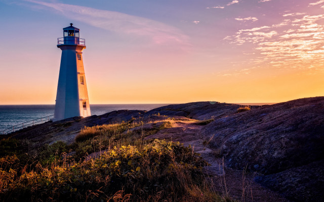 Lighthouse rockycliff ocean sunset pinksky free wallpaper for desktop - medium preview image