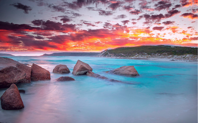 Sunset rocky beach blue water free wallpaper for desktop - medium preview image