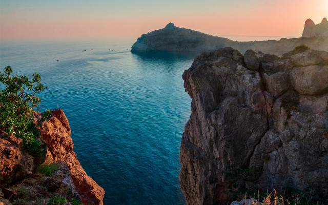 Rocky cliff ocean island boat free wallpaper for desktop - medium preview image