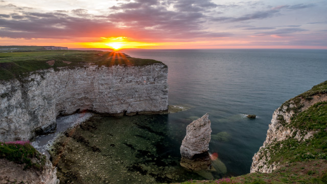 Sunset cliff rocks water boat free wallpaper for desktop - medium preview image