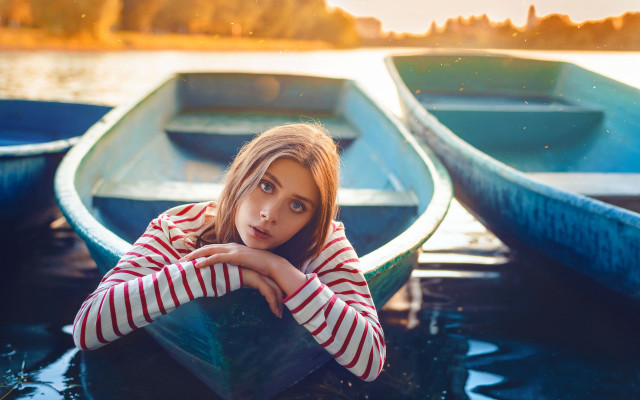 Woman sitting boat serious portrait free wallpaper for desktop - medium preview image