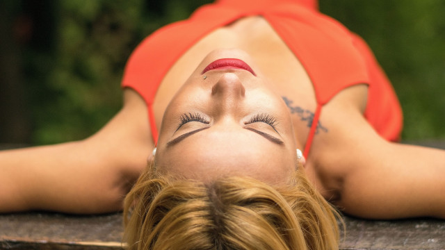 Woman red top laying on free wallpaper for desktop - medium preview image