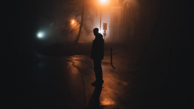 Man standing dark night streetlight free wallpaper for desktop - medium preview image