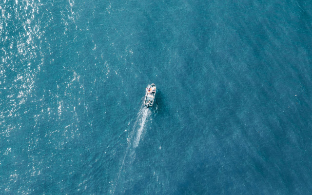 Boat ocean minimalism tiltshift astronaut free wallpaper for desktop - medium preview image