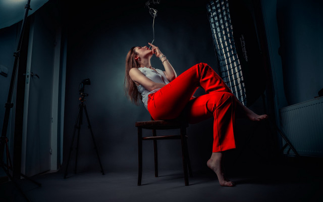 Woman red pants chair dark free wallpaper for desktop - medium preview image