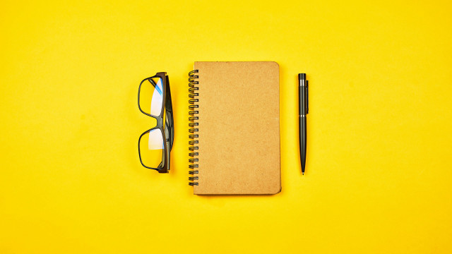 Notebook pen glasses yellow background free wallpaper for desktop - medium preview image