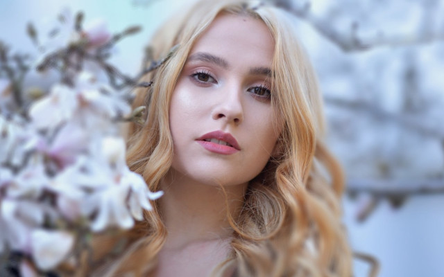 Serious blonde woman flower outdoors free wallpaper for desktop - medium preview image