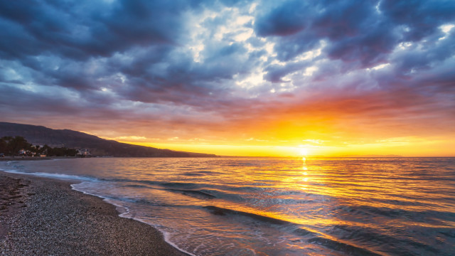 Sunset ocean beach mountains cloudy free wallpaper for desktop - medium preview image