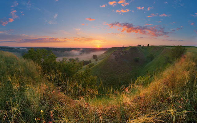 Sunset grassy hill valley clouds free wallpaper for desktop - medium preview image