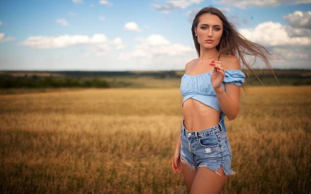 Woman blue top field wind free wallpaper for desktop - medium preview image