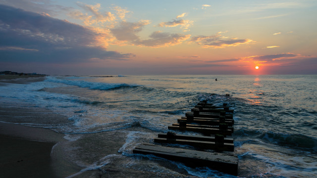 Sunset ocean benches person distant free wallpaper for desktop - medium preview image