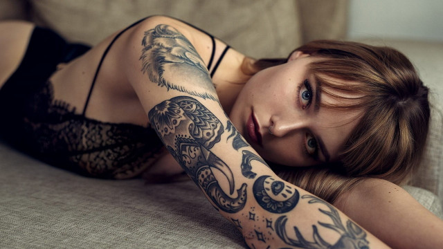 Woman tattoo laying couch arm free wallpaper for desktop - medium preview image