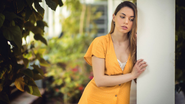 Woman leaning wall serious portrait #6 free wallpaper for desktop - medium preview image