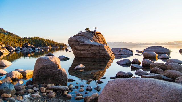 Person lake rocks trees mountain free wallpaper for desktop - medium preview image