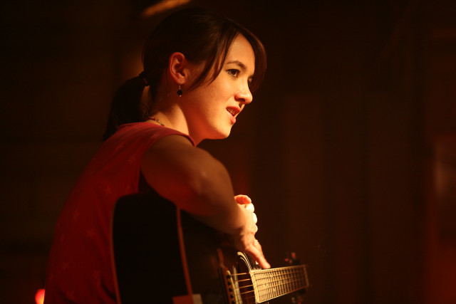 Woman guitar distance dark background free wallpaper for desktop - medium preview image