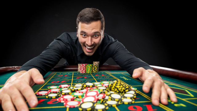 Excited man casino chips outstretched free wallpaper for desktop - medium preview image