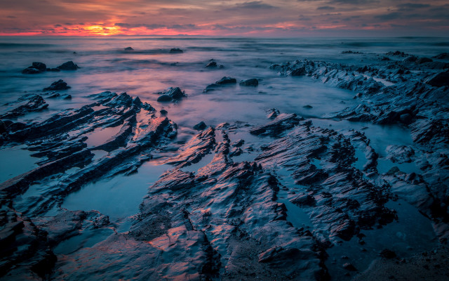 Rocky beach snowy sunset cloudy free wallpaper for desktop - medium preview image