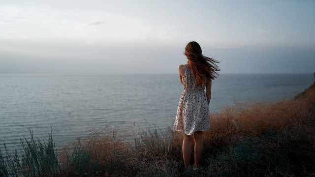 Woman cliff ocean wind dress free wallpaper for desktop - medium preview image