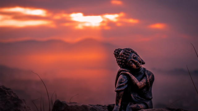 Statue sitting rock sunset clouds free wallpaper for desktop - medium preview image