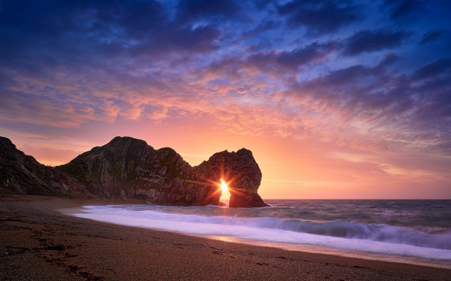 Beach sunset surfboard rock formation free wallpaper for desktop - medium preview image