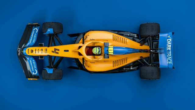 Yellow race car blue background free wallpaper for desktop - medium preview image