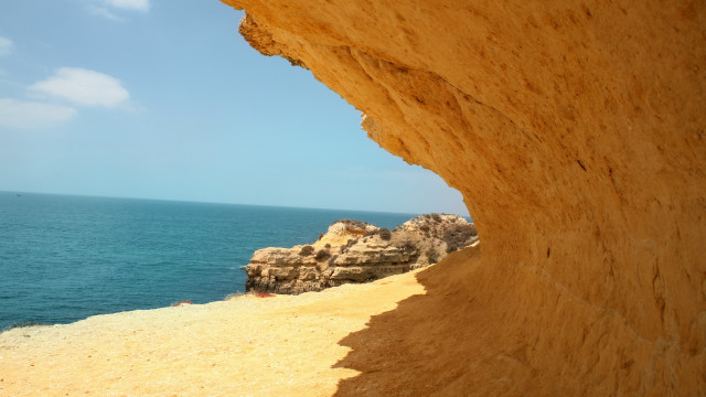 Ocean cliff beach rock boat free wallpaper for desktop - medium preview image