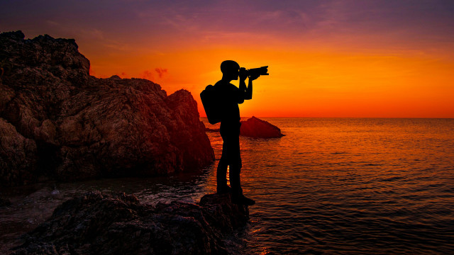 Person camera sunset mountain ocean free wallpaper for desktop - medium preview image